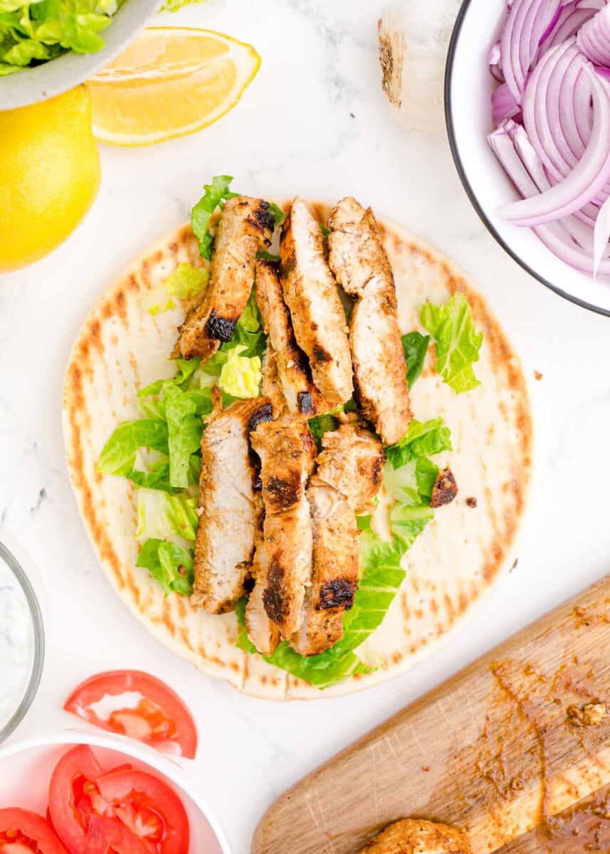 chicken and lettuce are all that's placed inside an open gyro.