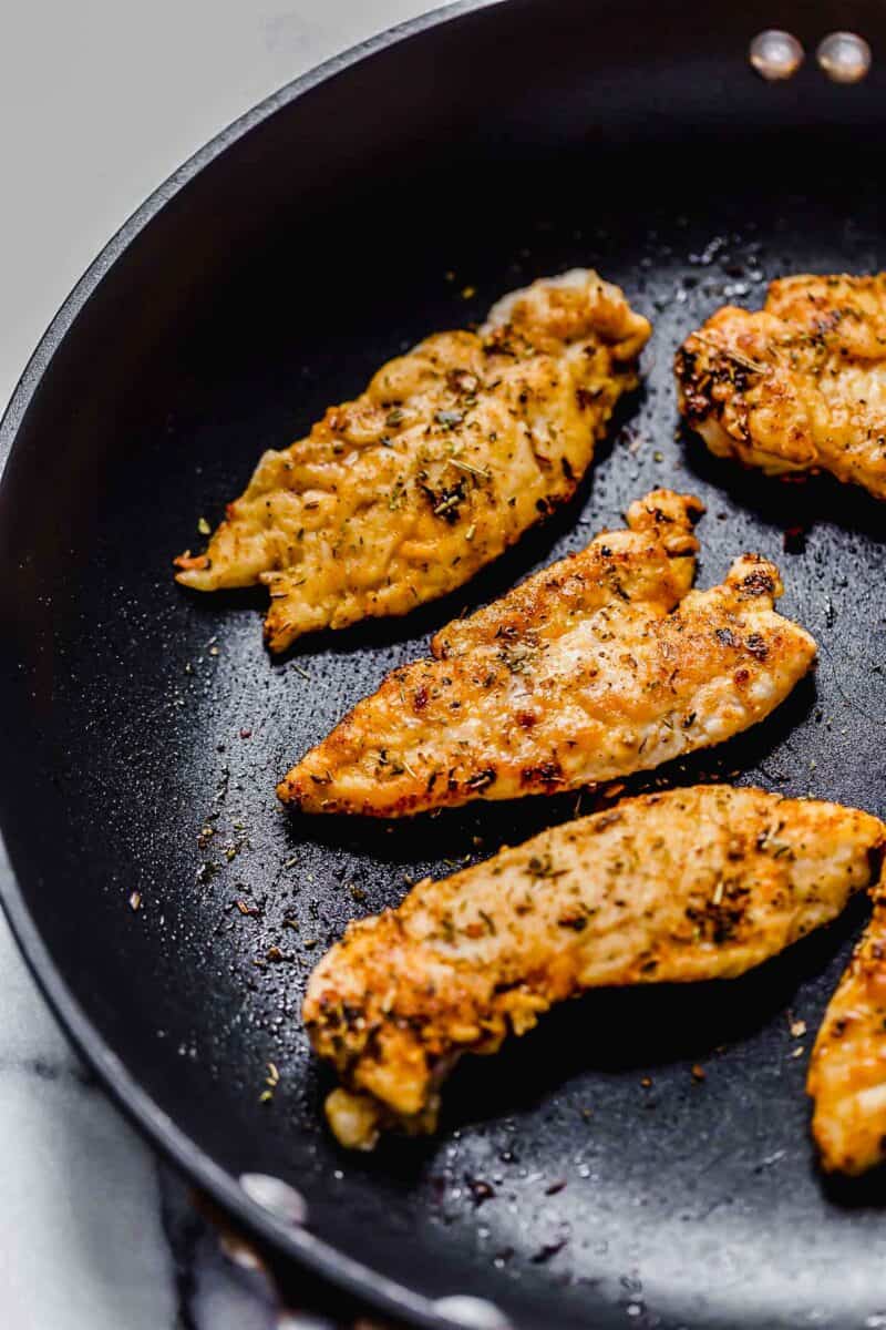 seasoned chicken tenders in a nonstick skillet