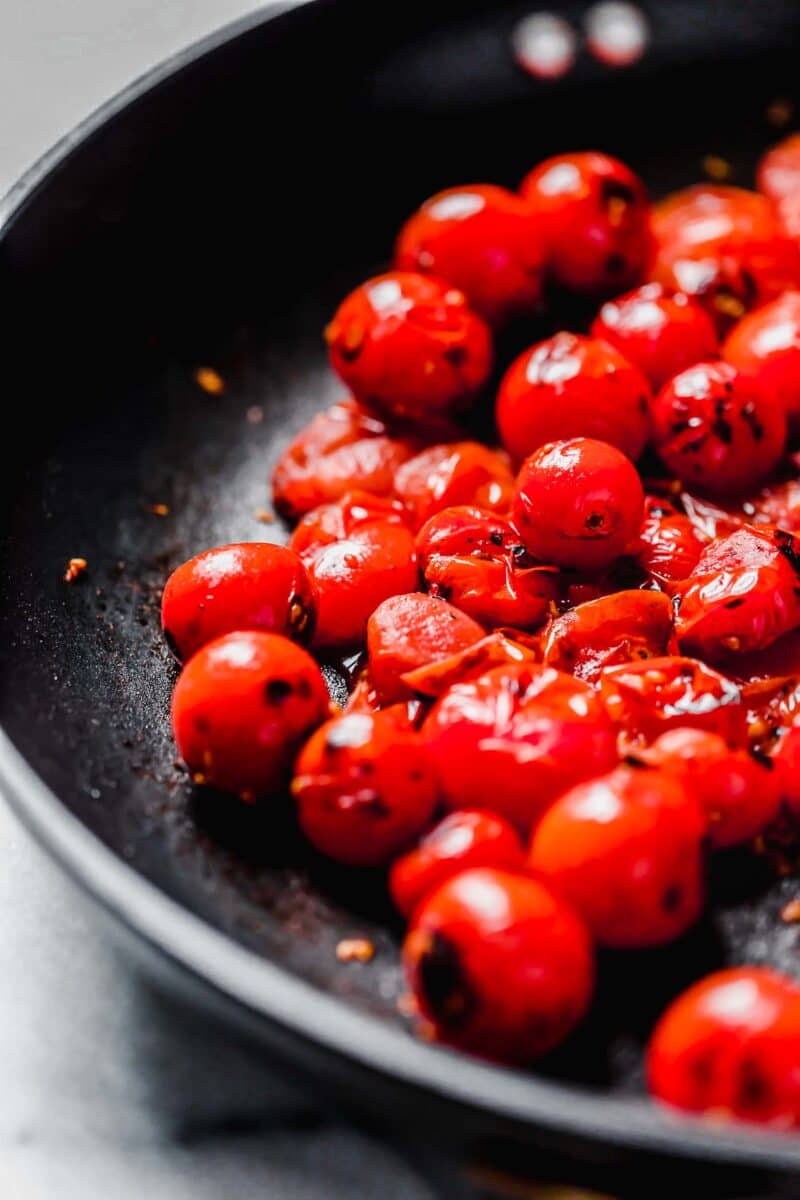 burst cherry tomatoes in a nonstick skillet