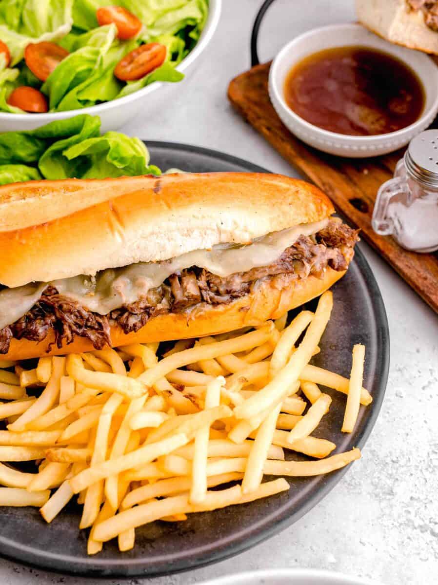 fries are served next to a beef sandwich.