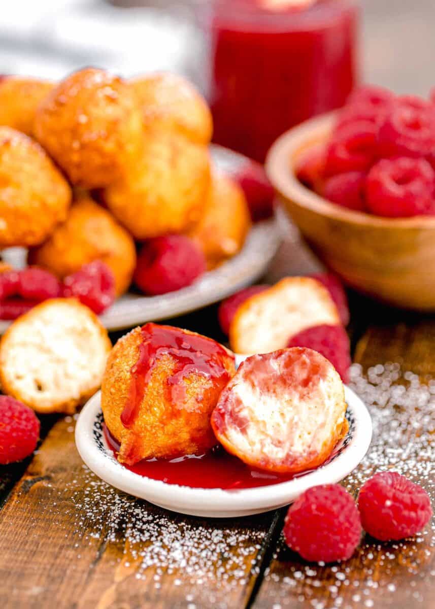 raspberry sauce garnished a small serving of cheesecake bites.