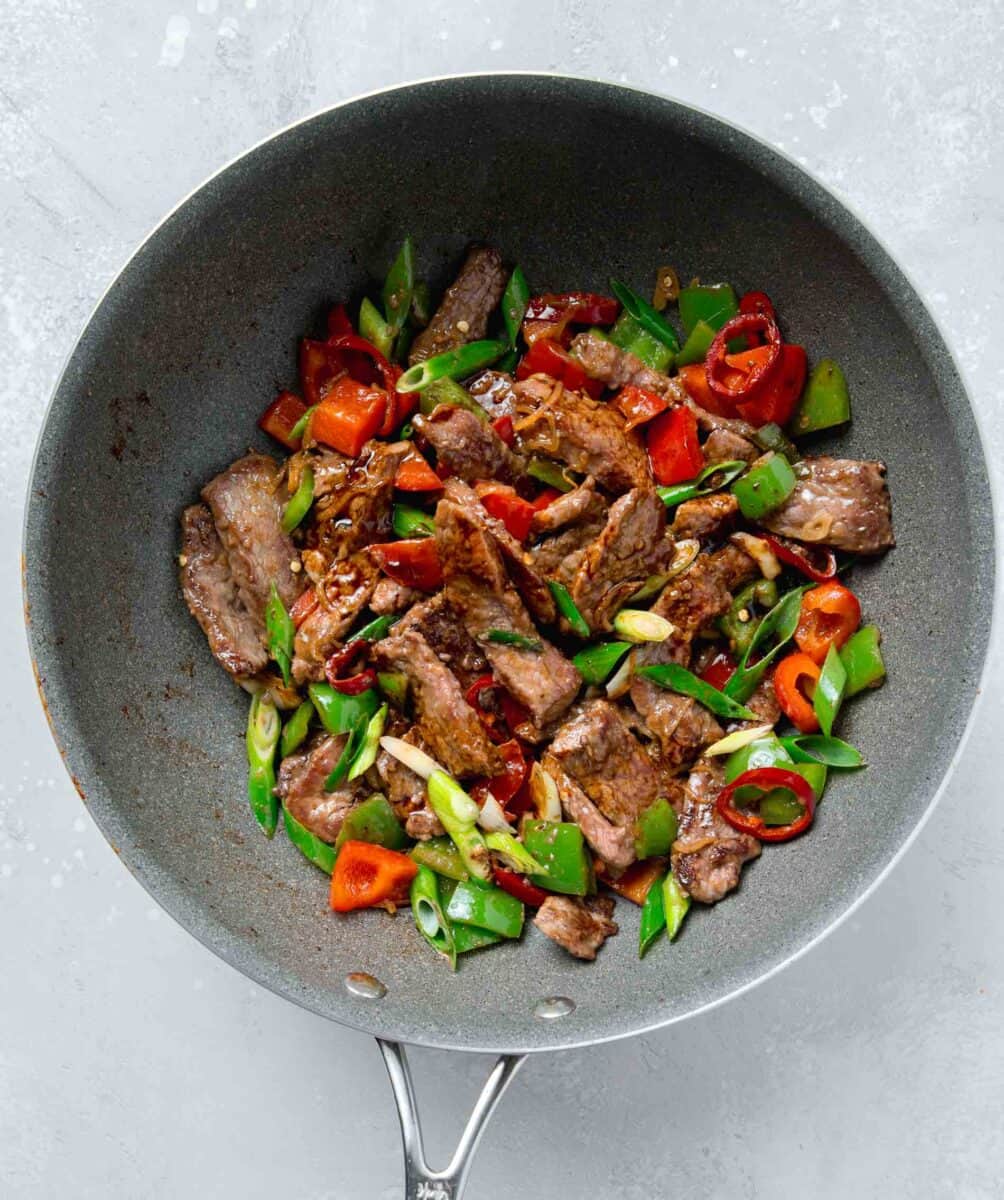 sauce for hunan beef poured into the skillet