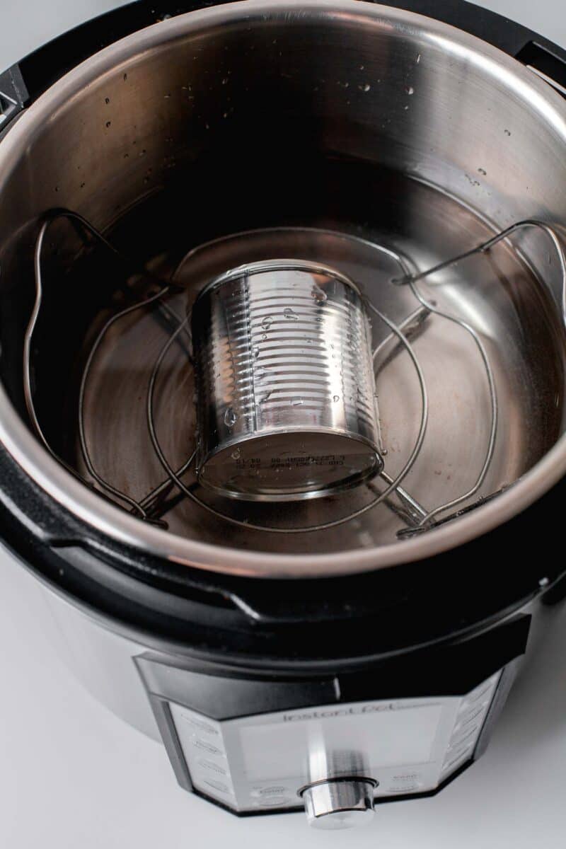 a silver tin can is placed in an instant pot.