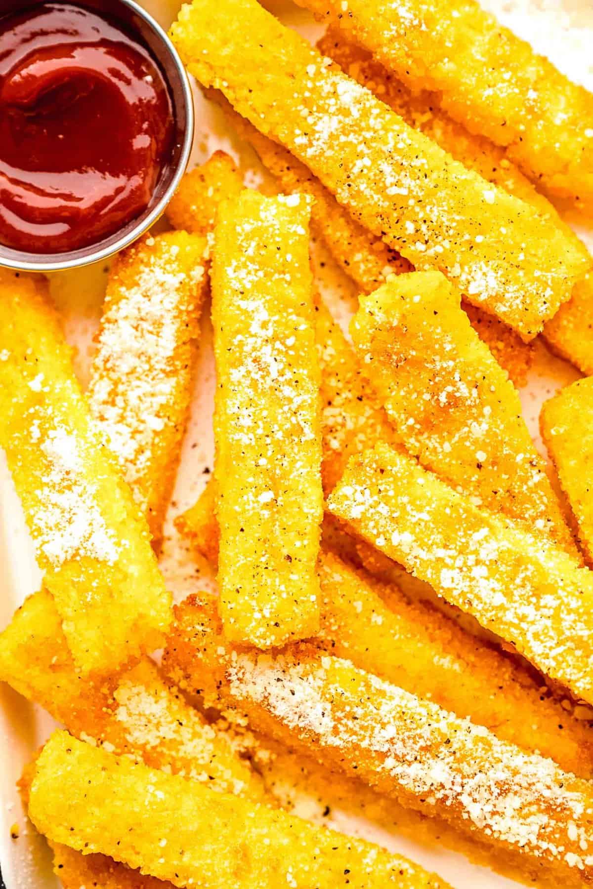 Closeup of polenta fries with ketchup.