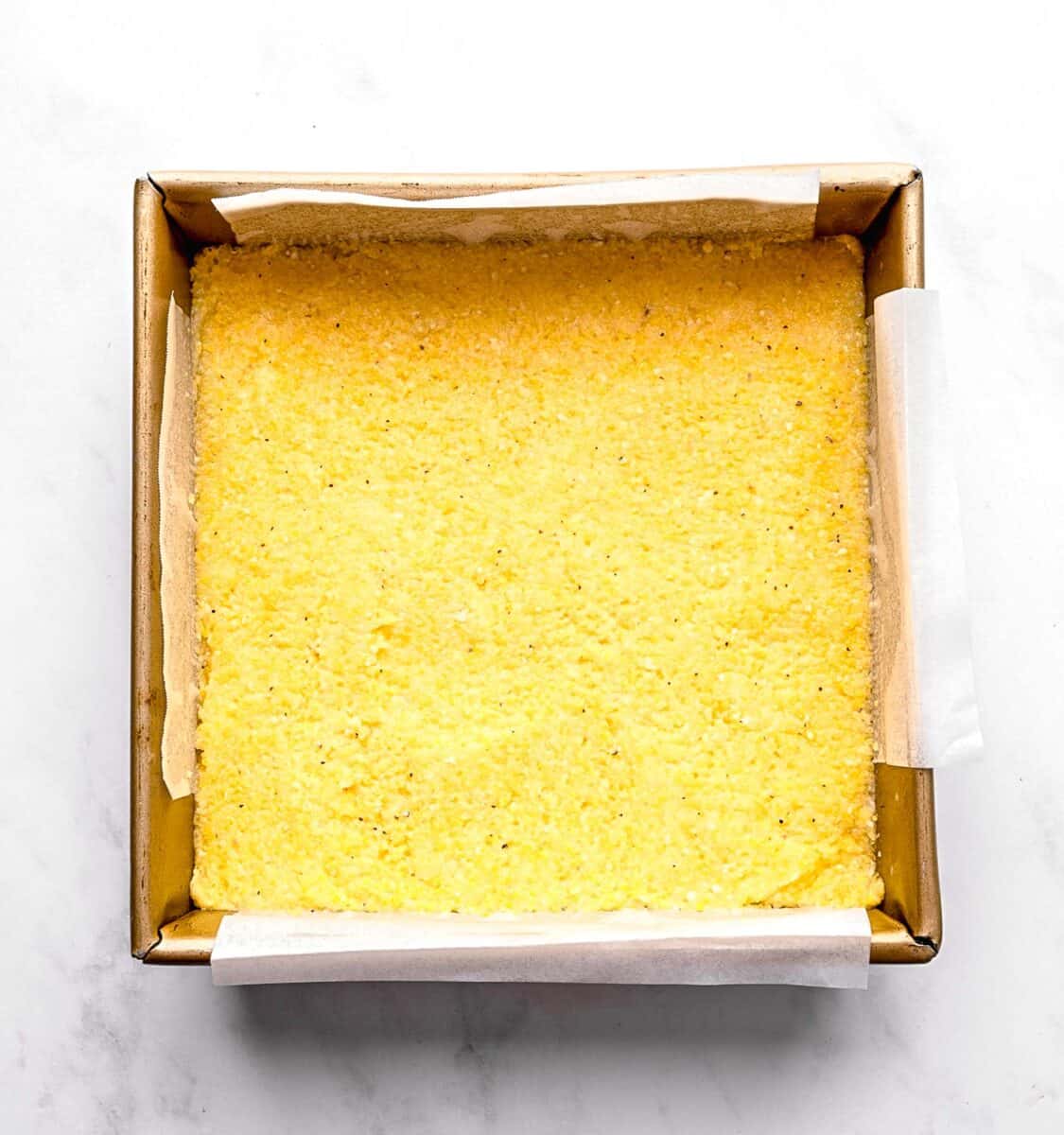 Chilled polenta in a baking pan.