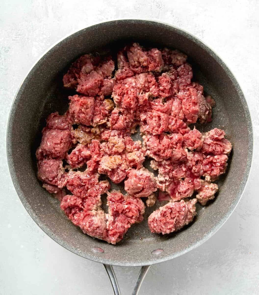 ground beef being cooked in a nonstick skillet