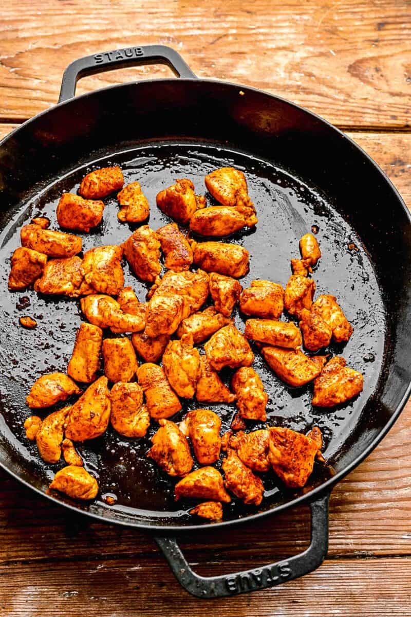 Browning chicken pieces in a pan.