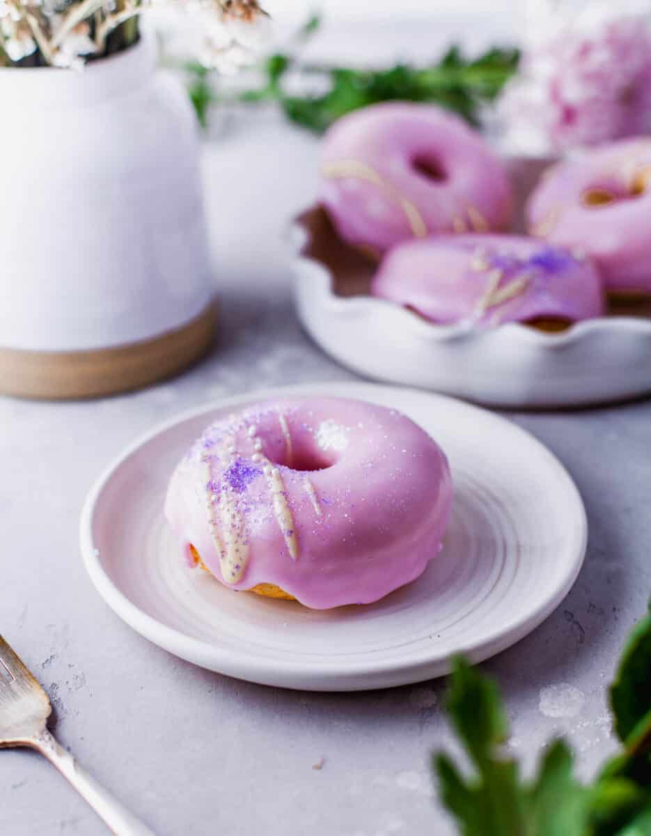 a singe pink frosted donut is plated
