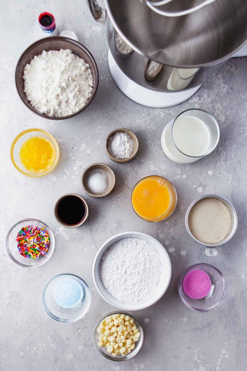 the ingredients for baked vanilla donuts are spread across a countertop