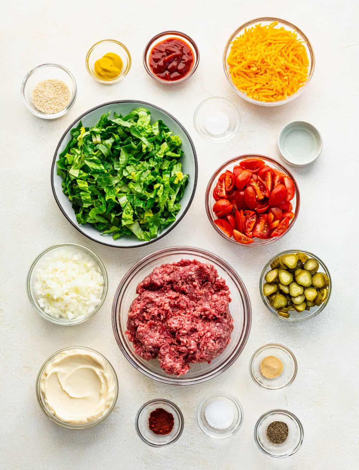Ingredients for Big Mac salad separated into bowls.