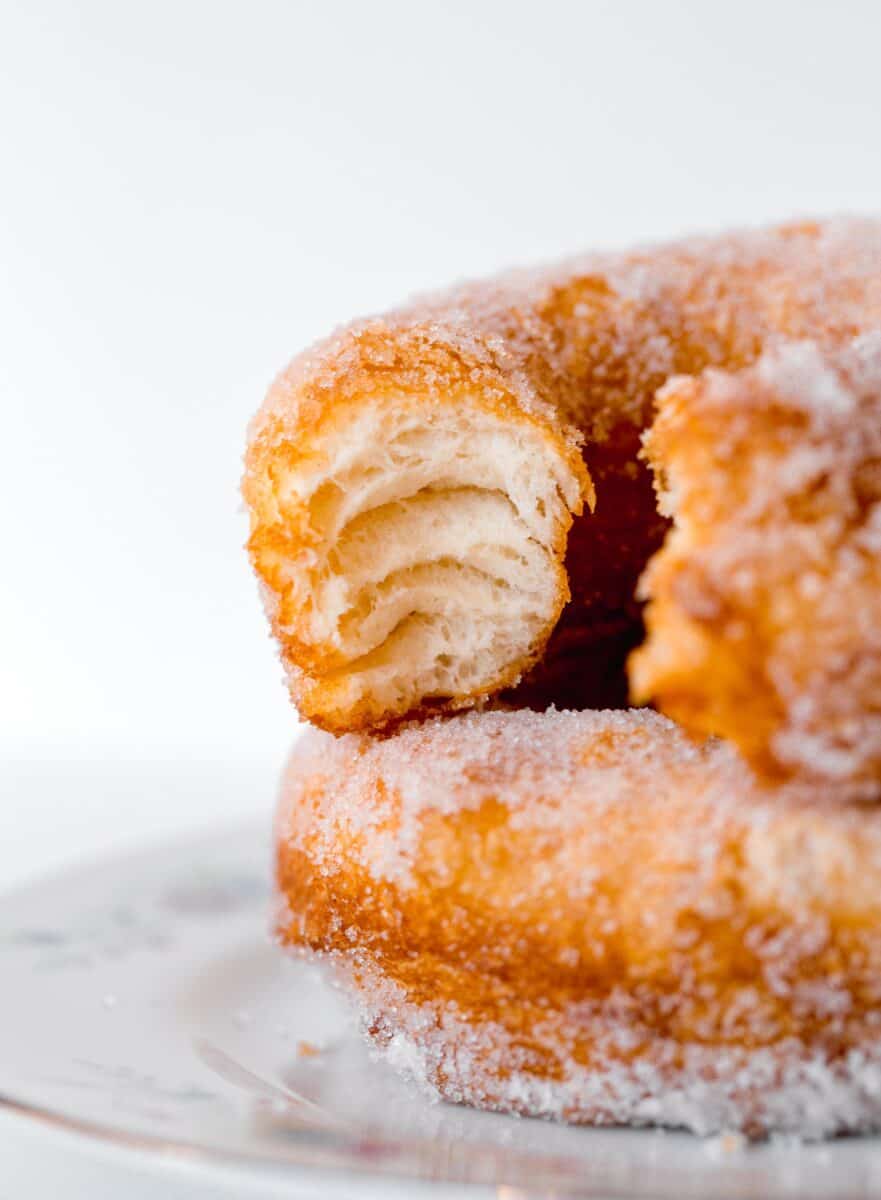 inside of a biscuit donut shows the fluffy layers that the biscuit dough has when fried