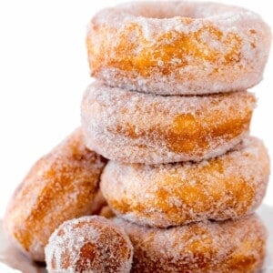 a stack of 4 biscuit donuts with a donut hole in front