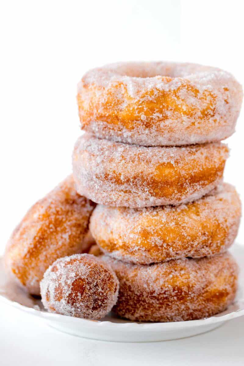 a stack of 4 biscuit donuts with a donut hole in front