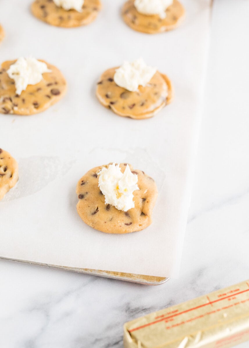 a cheesecake dollop is placed in the center of raw cookie dough pieces.