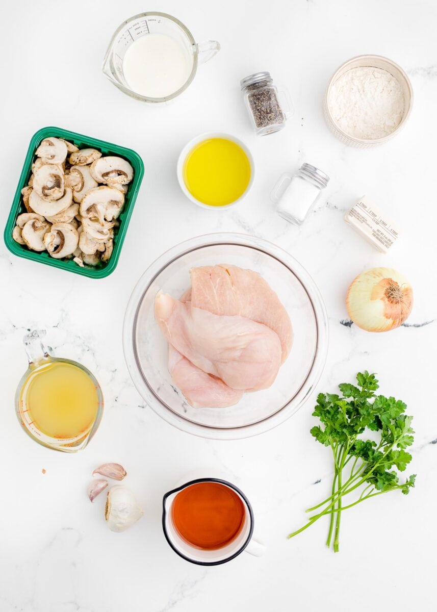 the ingredients for chicken marsala are placed on a white countertop.