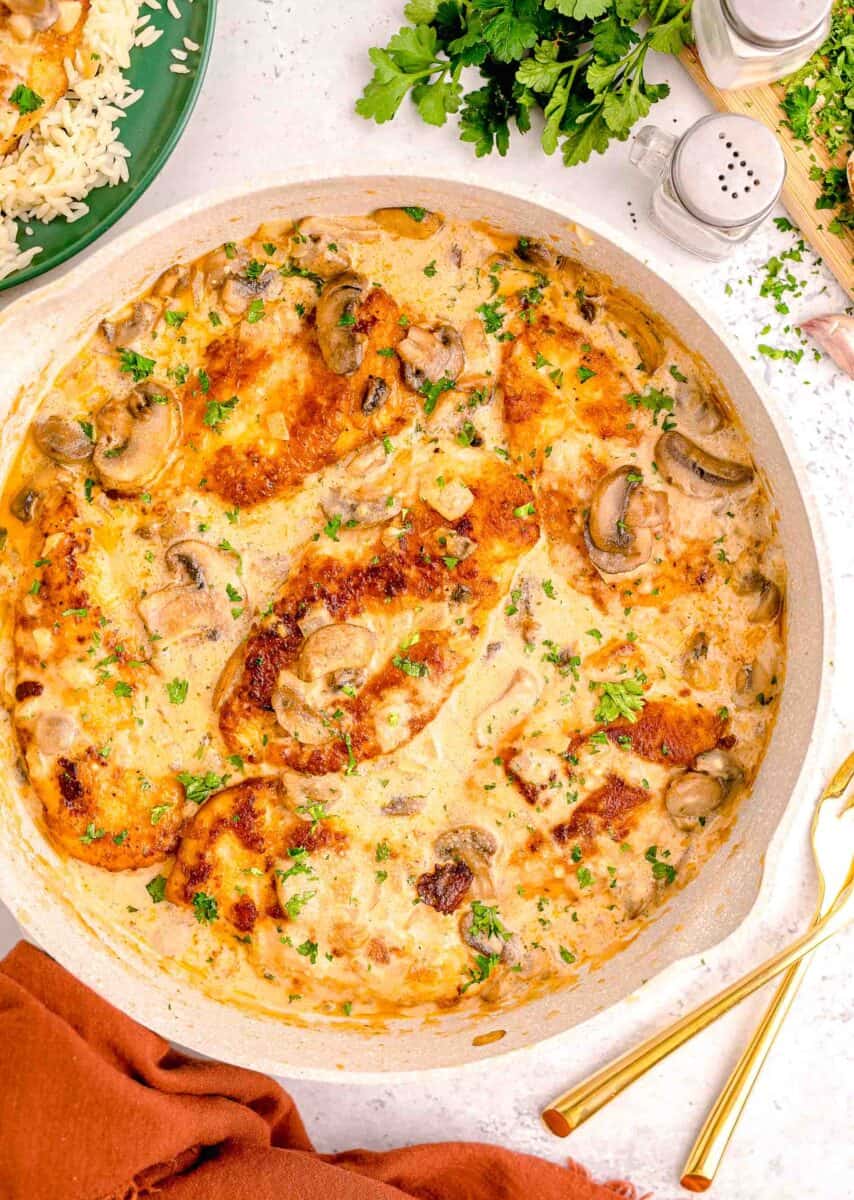 a pot is filled with creamy chicken marsala.