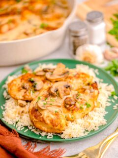 a green plate is topped with chicken marsala