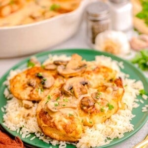 a green plate is topped with chicken marsala