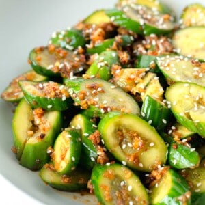 smashed asian cucumber salad in a white bowl