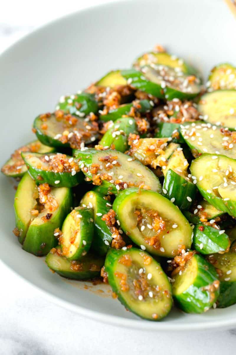 smashed asian cucumber salad in a white bowl