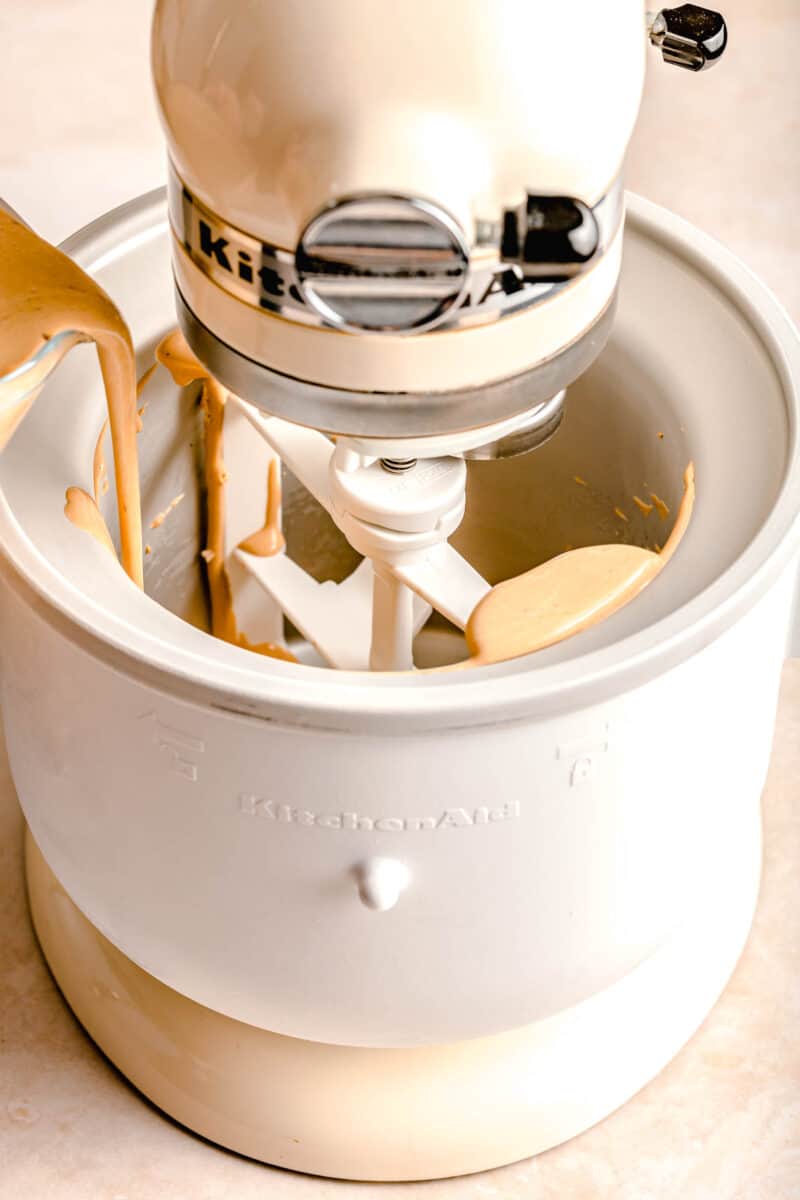 espresso ice cream mixture being poured into a kitchenaid stand mixer ice cream maker