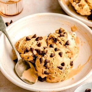 3 scoops of espresso chocolate chip ice cream in a white bowl with an antique spoon