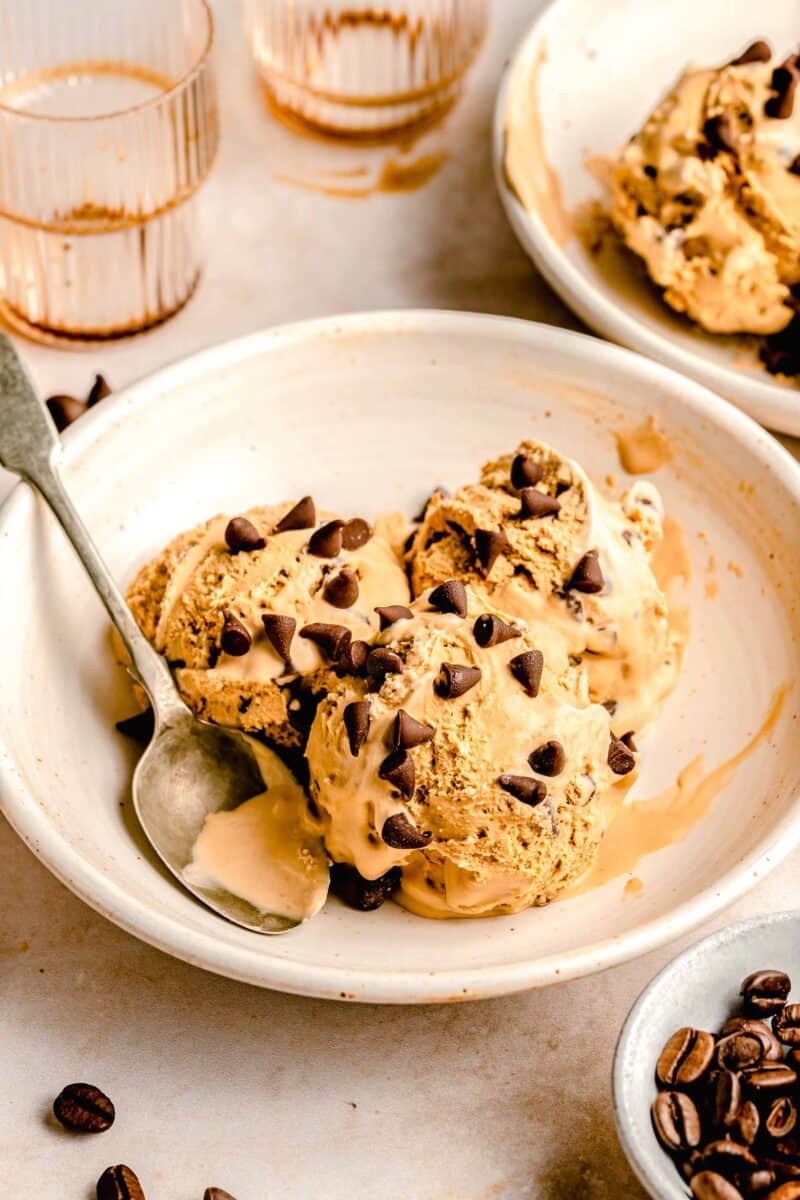 3 scoops of espresso chocolate chip ice cream in a white bowl with an antique spoon