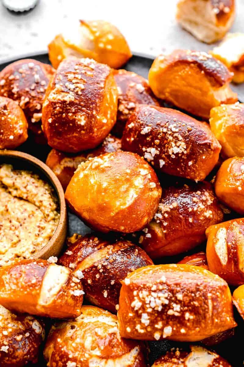 Closeup of pretzel bites on a plate with whole-grain mustard.