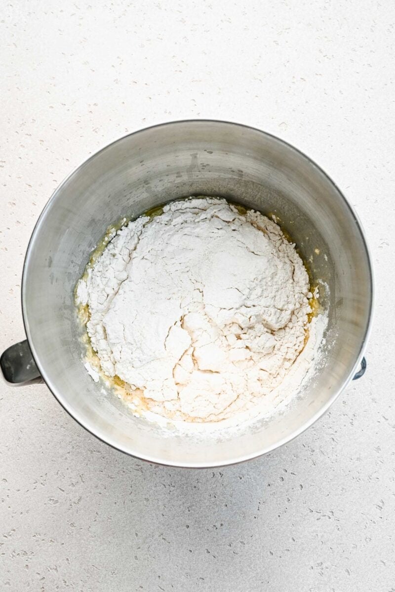 Adding dry ingredients to pretzel dough.