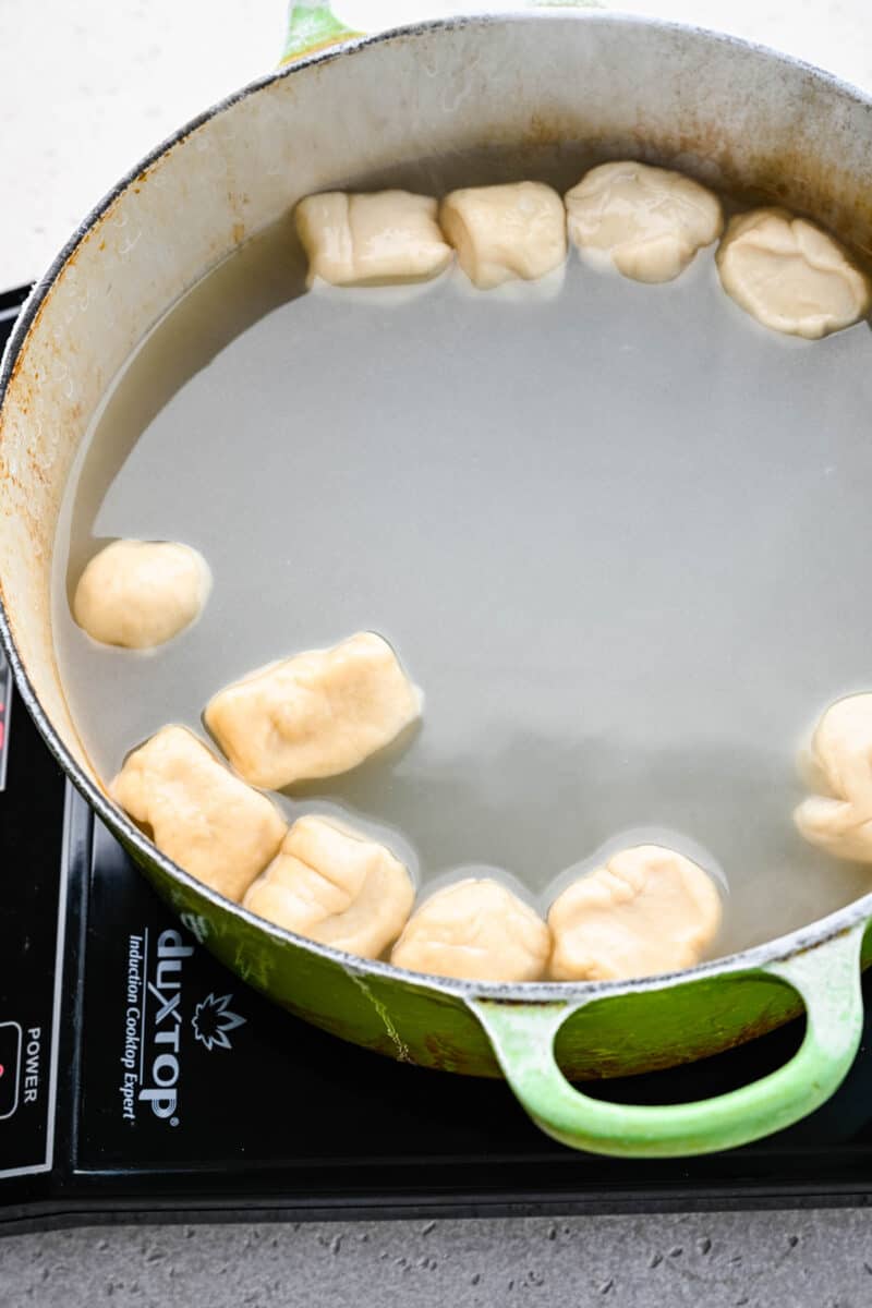 Boiling pretzel bites in baking soda water.