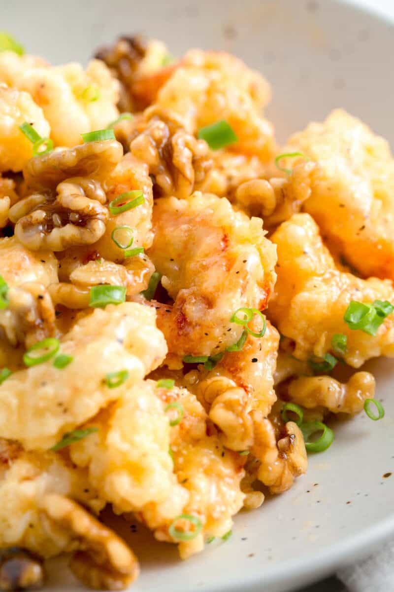 honey walnut shrimp with fresh scallions and walnuts on top