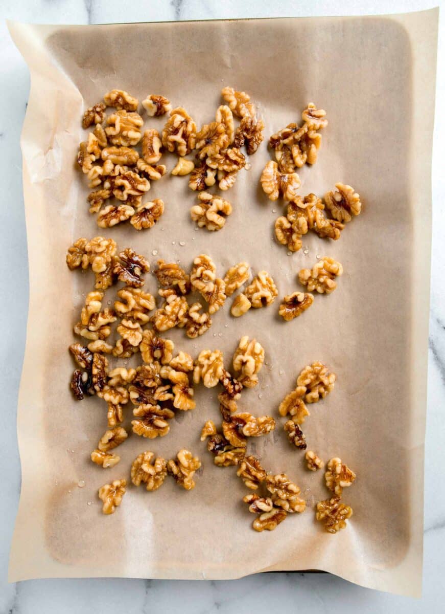 walnuts on a parchment paper lined baking sheet