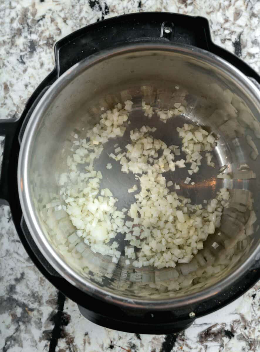 diced onions being sautéd in instant pot