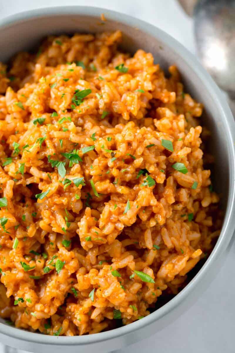 overhead image of instant pot mexican rice in a bowl with fresh parsley garnished on top