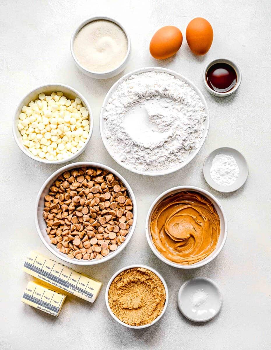 the ingredients for peanut butter cookie bars are placed on a white surface.