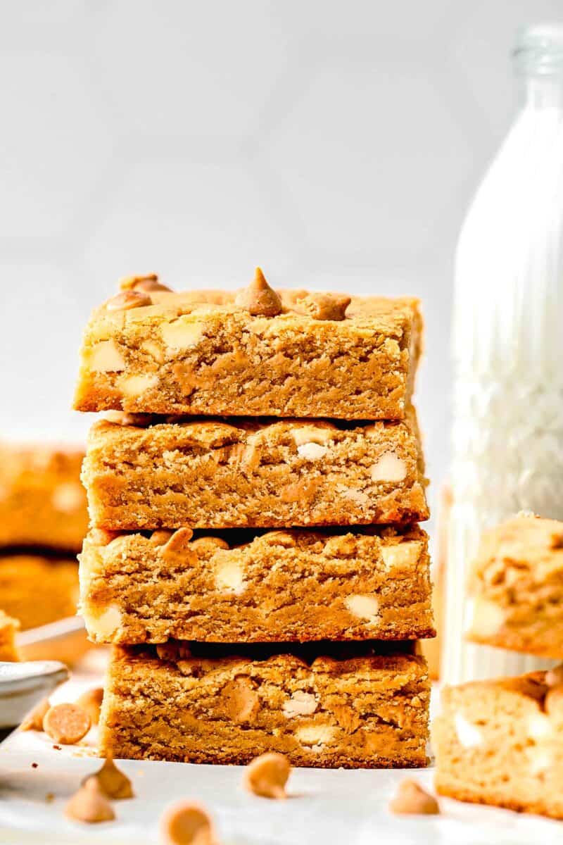 a stack of four cookie bars is presented on a white surface.