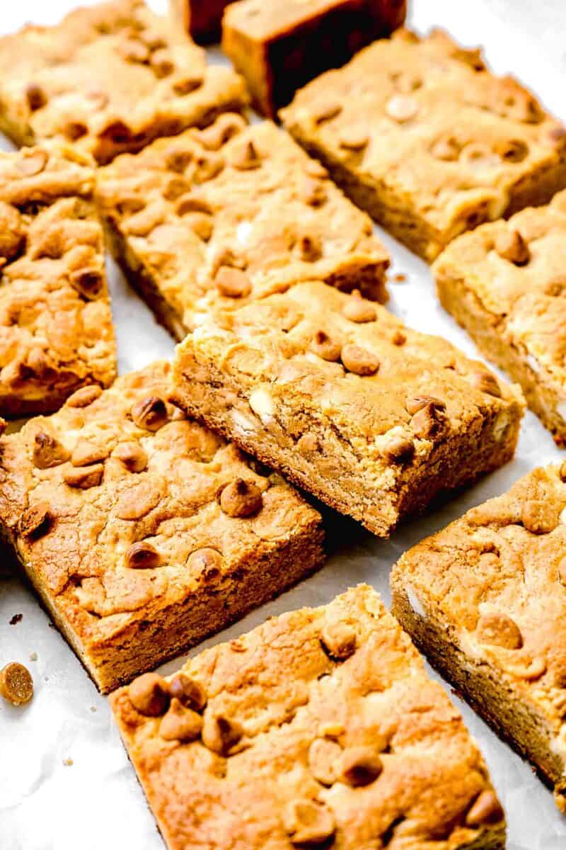 peanut cookie bars are cut and placed on a white countertop.