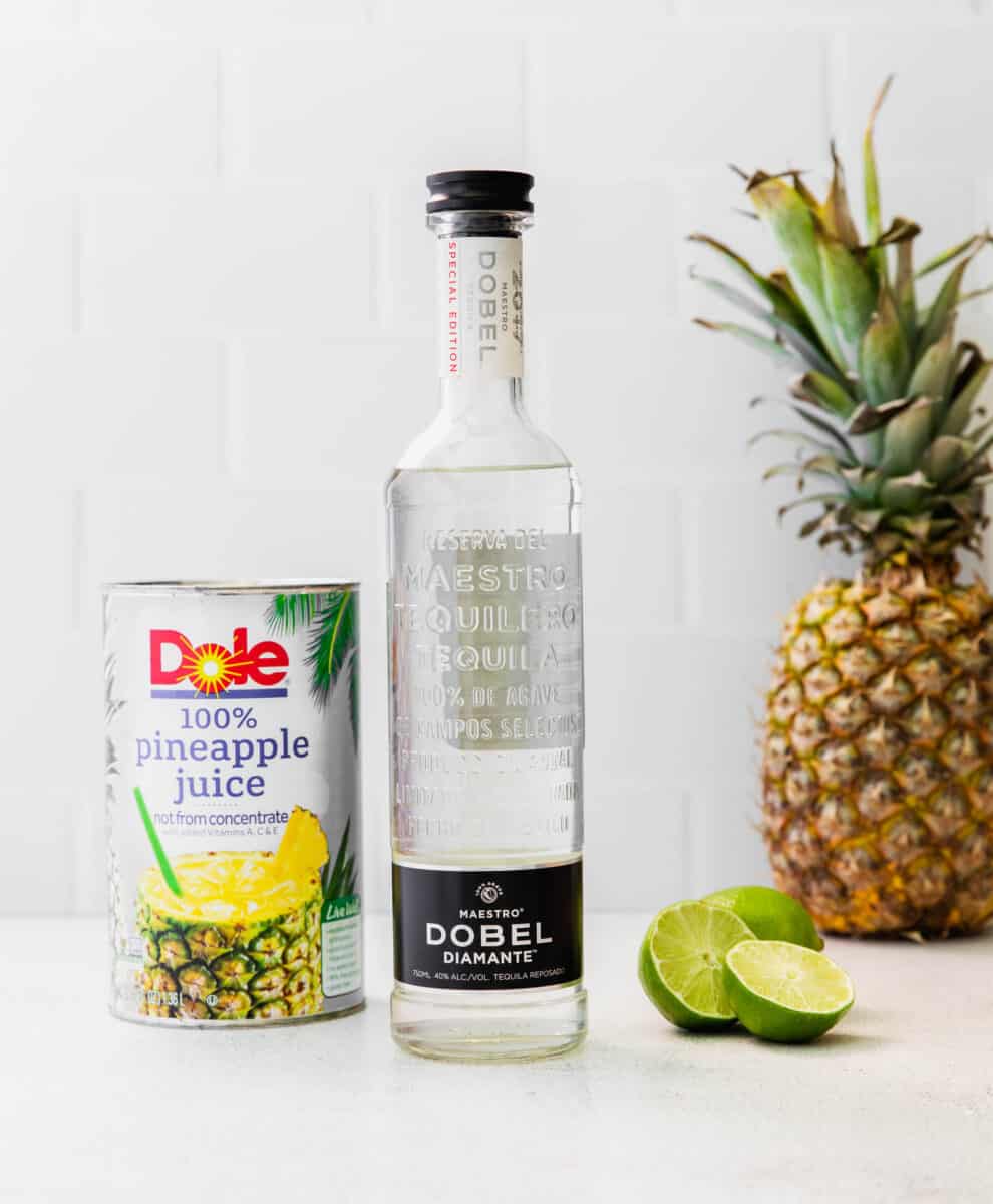 the ingredients for pineapple paloma are placed on a white countertop