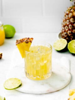 lime slices are placed around a paloma glass
