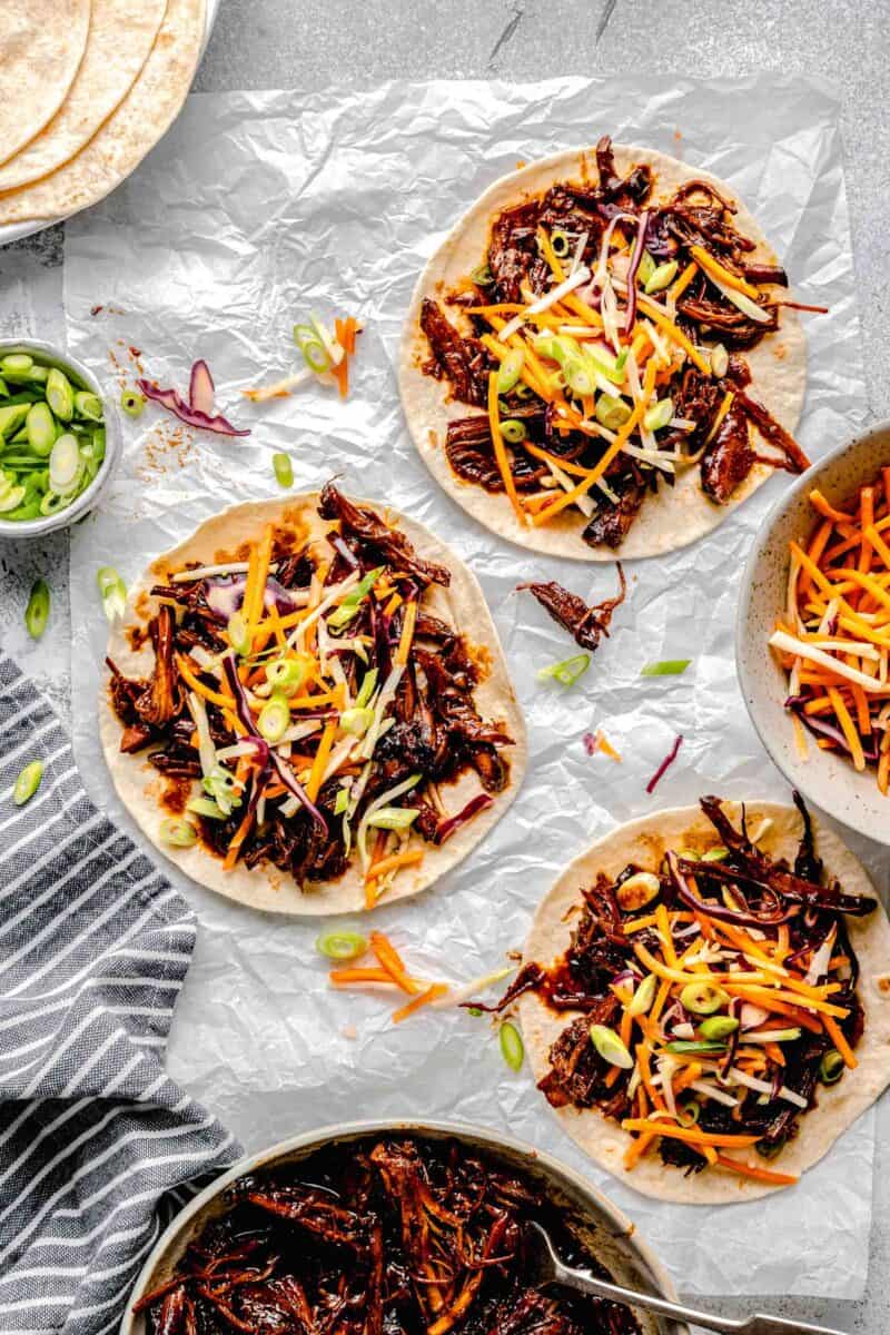 several tacos are topped with tangy slaw.