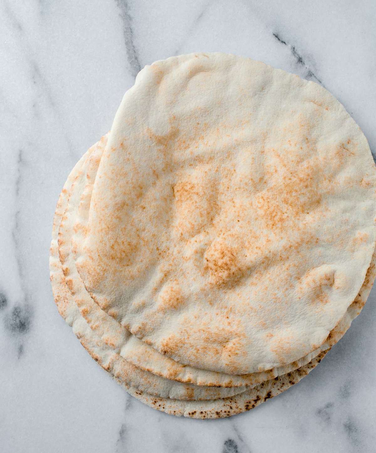 a photo of pita bread on a marble countertop
