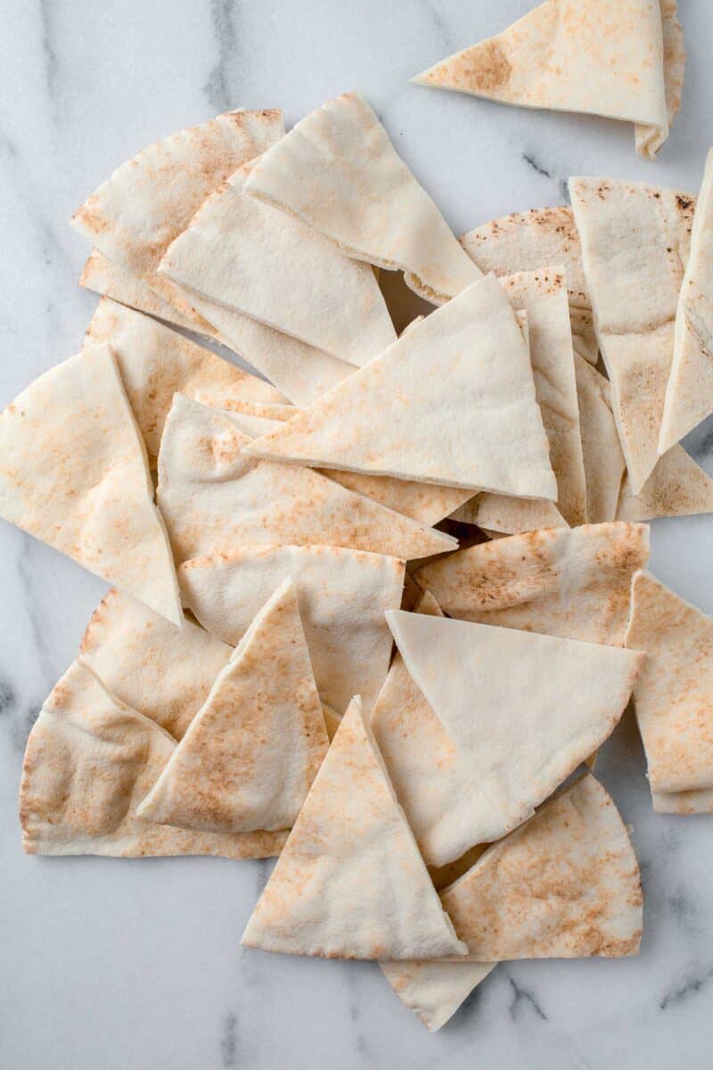 pita bread sliced into triangles on a marble countertop