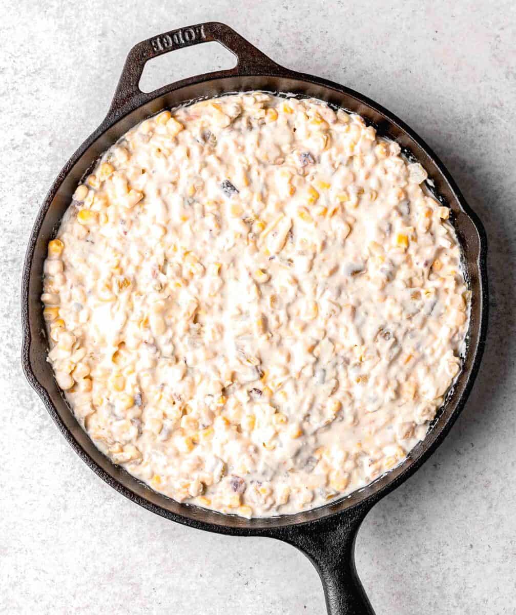 ingredients for corn dip all mixed together in the cast iron skillet