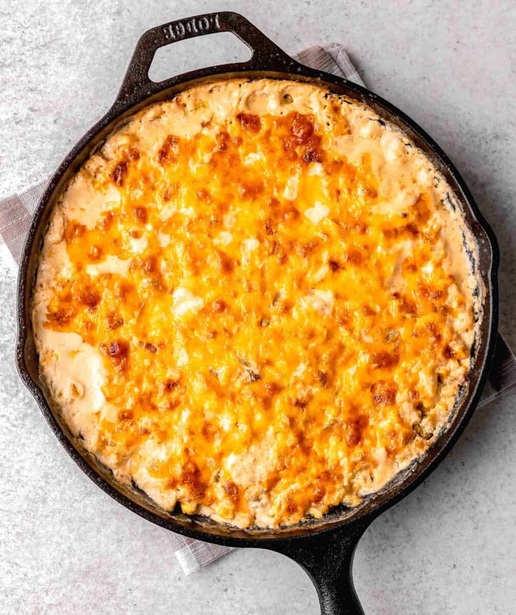 melted cheese on top of the baked corn dip in a skillet