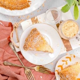 pie has been sliced and plated on two different plates next to the dish