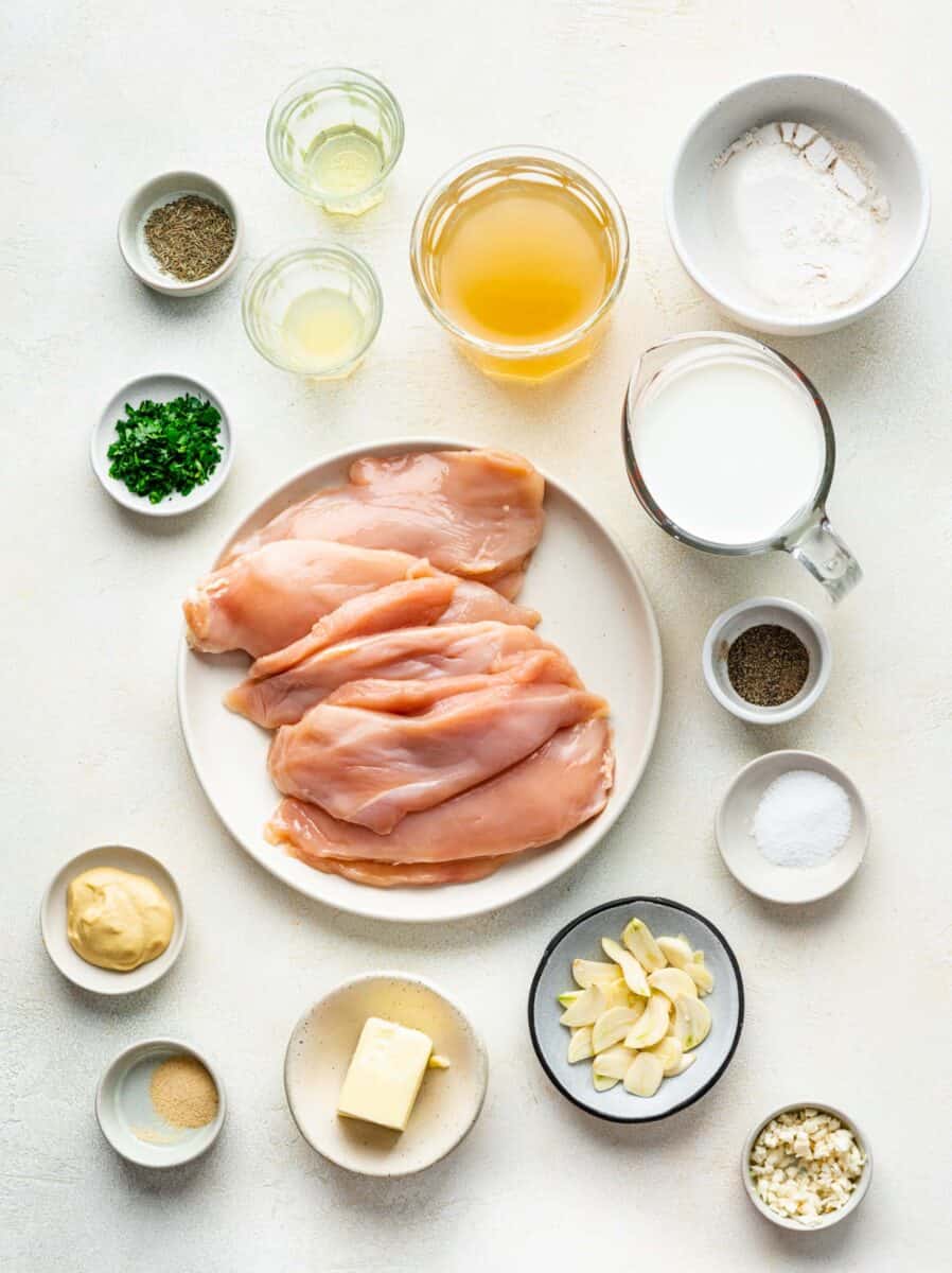 the ingredients for garlic butter chicken are placed on a white surface