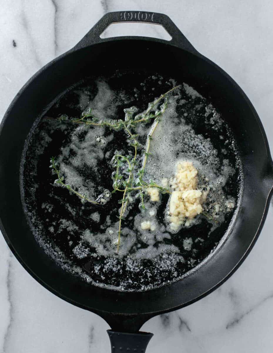 butter, minced garlic, and thyme in a cast iron skillet