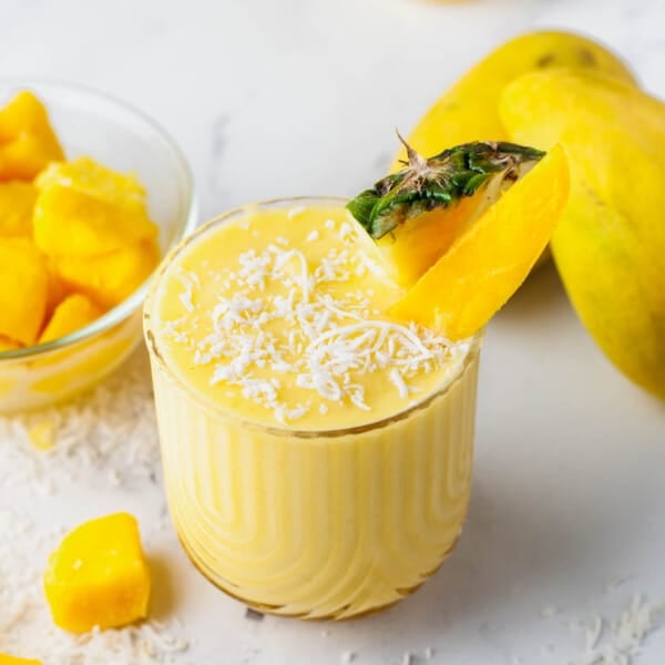 a short glass is filled with mango colada