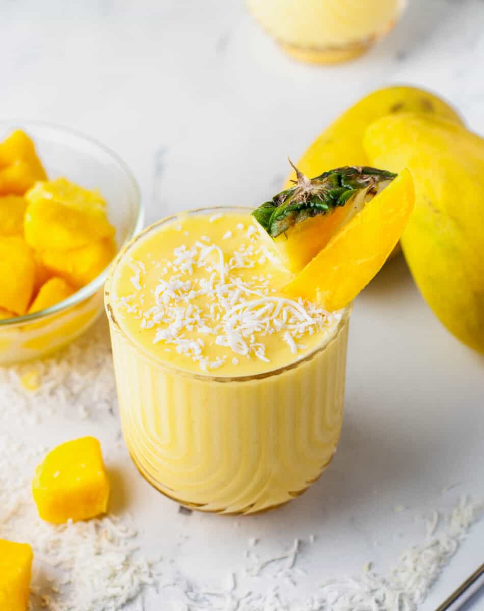a short glass is filled with mango colada