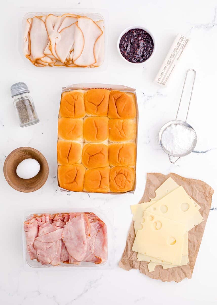 the ingredients for monte cristo sliders are presented on a white surface